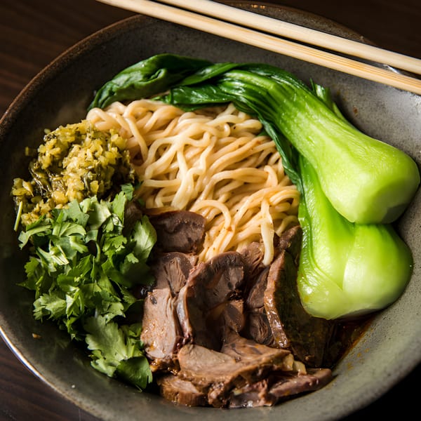 Xian Sushi and Noodle's beef noodle soup with bok choy, cilantro, and pickled vegetables.